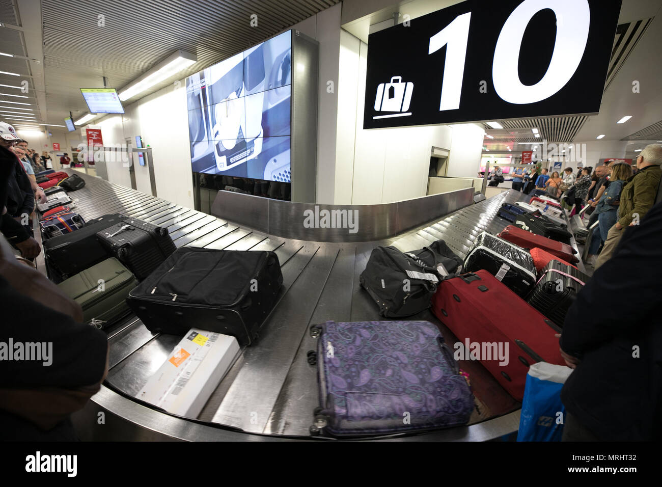 Transport tape, luggage tourists people waiting for suitcase. Rome Fiumicino airport. Italy