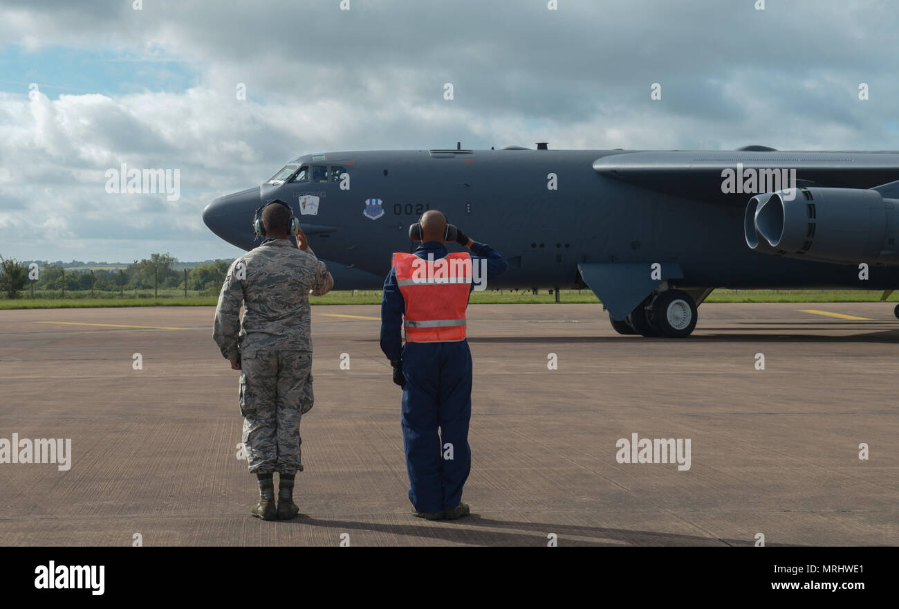 Senior Airman Irvin McArthur (left) and Staff Sgt. Sudarien Smith, 20th Airframe and Power Plant General crew chiefs, salute a pilot from the 20th Bomb Squadron prior to takeoff at Royal Air Force Fairford, United Kingdom, June 11, 2017. Roughly 800 AFGSC Airmen and eight strategic bombers to include B-1B Lancers, B-2 Spirits and B-52H Stratofortresses deployed to RAF Fairford in support of bomber assurance and deterrence missions in the U.S. European Command area of responsibility throughout the month of June. (U.S. Air Force photo/Senior Airman Curt Beach) Stock Photo