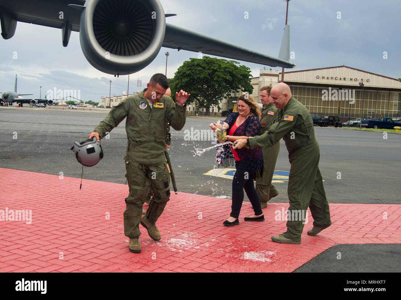 Friends and family members spray Col. Charles Velino, 15th Operations