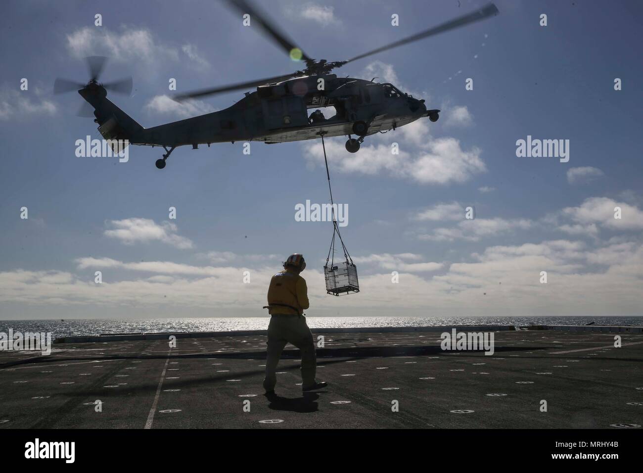 PACIFIC OCEAN – An MH-60 Seahawk lowers a basket onto the flight deck ...