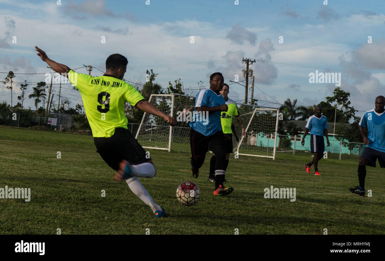 FREEPORT, Bahamas (June 14, 2017) Boatswain's Mate 3rd Class Danny Vasquez attempts a shot during a soccer game between Sailors from the amphibious assault ship USS Iwo Jima (LHD 7) and the Freeport Rugby and Football Club. Iwo Jima is in Freeport for a scheduled port visit to continue growing the long-standing relationship between the U.S. and the Bahamas and allow the ship’s crew to experience the culture of the Caribbean nation. (U.S. Navy photo by Mass Communication Specialist 3rd Class Daniel C. Coxwest/Released) Stock Photo