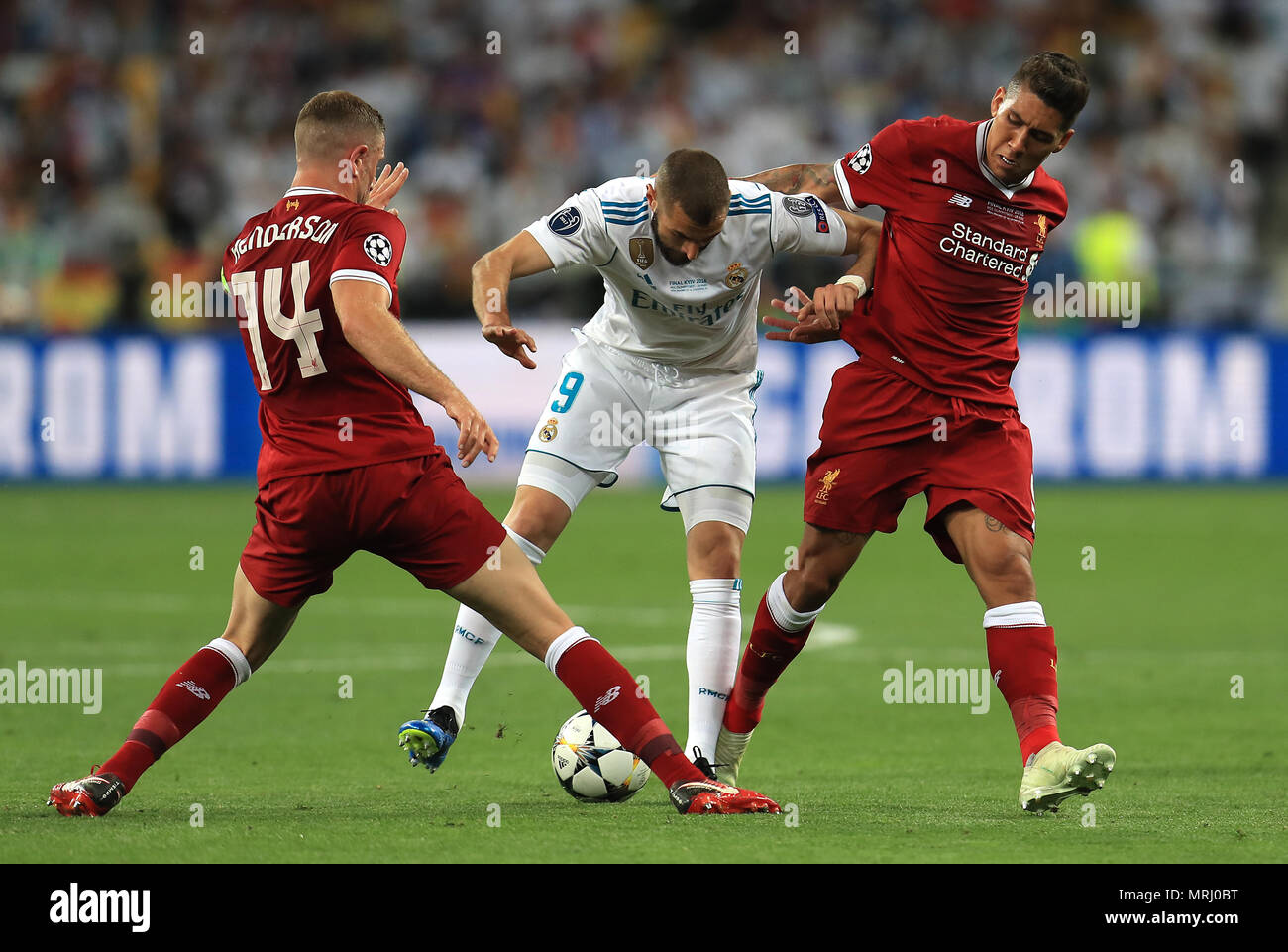 Liverpool's Jordan Henderson (left) and Roberto Firmino (right) battle for the ball with Real Madrid's Karim Benzema (centre) during the UEFA Champions League Final at the NSK Olimpiyskiy Stadium, Kiev. PRESS ASSOCIATION Photo. Picture date: Saturday May 26, 2018. See PA story SOCCER Champions League. Photo credit should read: Mike Egerton/PA Wire Stock Photo