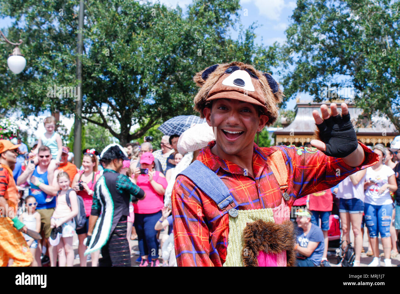 A portrait of a cheerful funny cute man in a fancy costume of raccoon. Photo taken on a Disney parade in Disneyworld. Stock Photo