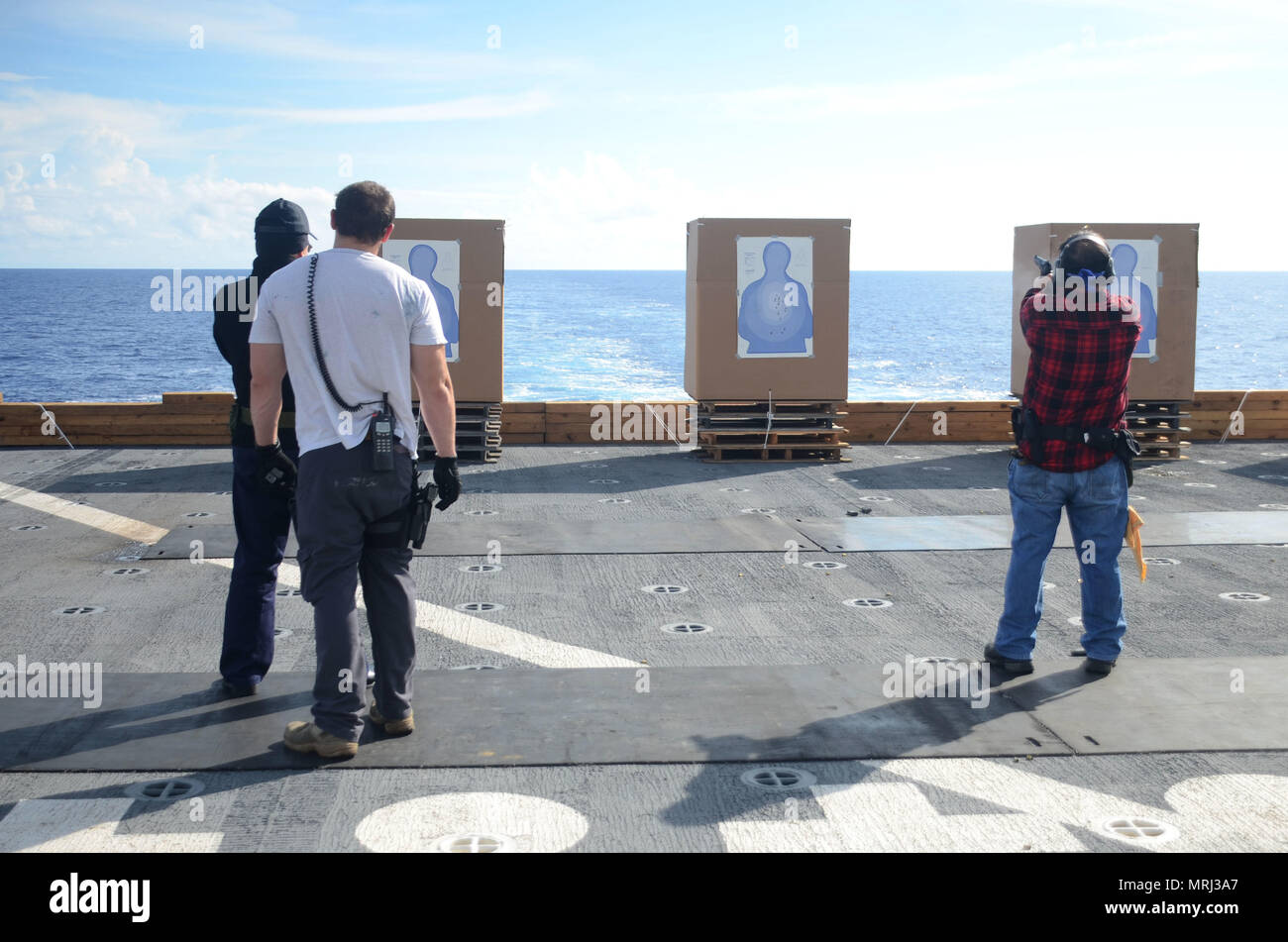 170621-N-WJ640-023 PACIFIC OCEAN (June 21, 2017) Civilian Mariners conduct live fire arms training onboard the flight deck of USNS Sacagawea (T-AKE 2) during Koa Moana 17, June 21. The Koa Moana 17 (Ocean Warrior) exercise is designed to improve interoperability; enhance military-to-military relations and expose Marine Corps forces to different types of terrain for familiarity in the event of a natural disaster or crisis in the region. (U.S. Navy photo by Mass Communication Specialist 3rd Class Madailein Abbott) Stock Photo