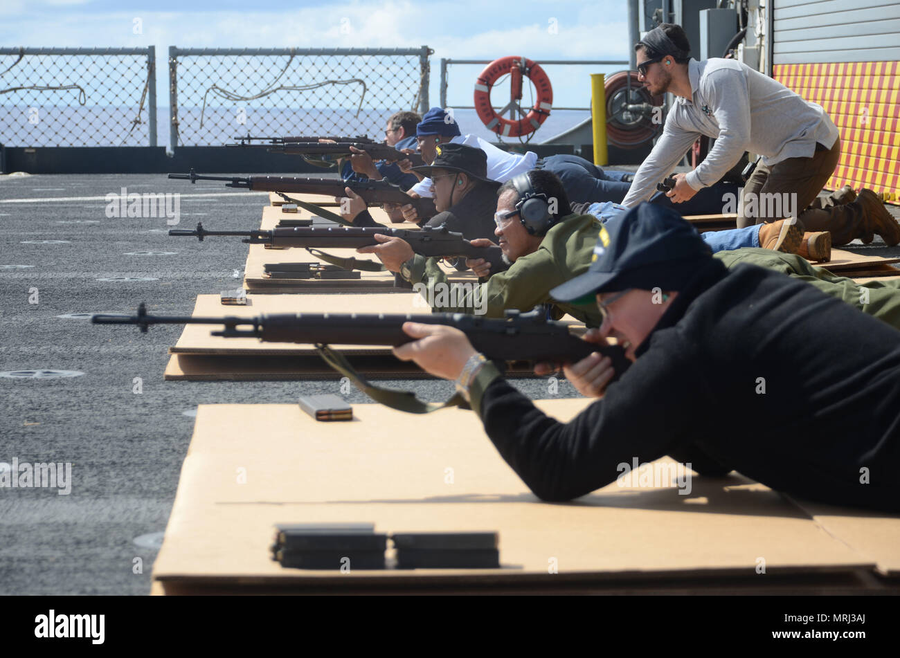 170621-N-WJ640-063 PACIFIC OCEAN (June 21, 2017) Civilian Mariners participate in live fire arms training onboard the flight deck of USNS Sacagawea (T-AKE 2) during Koa Moana 17, June 21. The Koa Moana 17 (Ocean Warrior) exercise is designed to improve interoperability; enhance military-to-military relations and expose Marine Corps forces to different types of terrain for familiarity in the event of a natural disaster or crisis in the region. (U.S. Navy photo by Mass Communication Specialist 3rd Class Madailein Abbott) Stock Photo