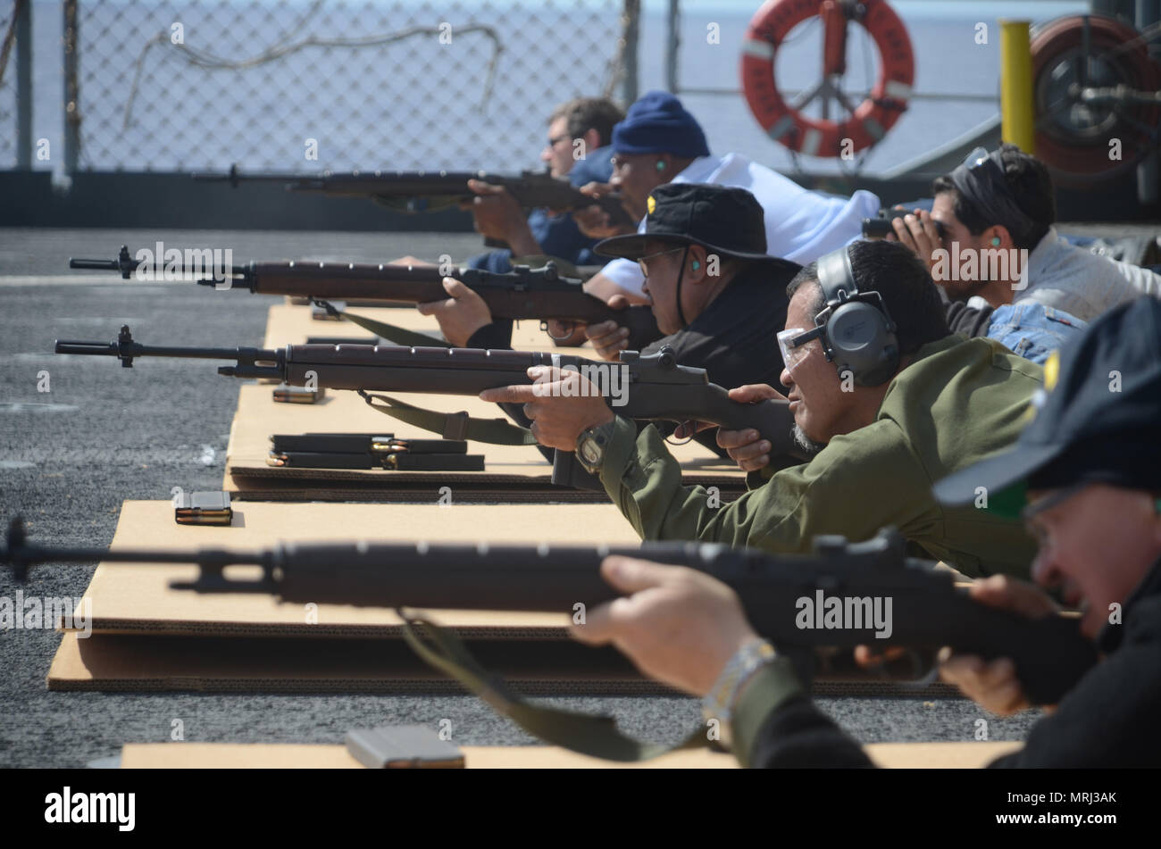 170621-N-WJ640-068 PACIFIC OCEAN (June 21, 2017) Civilian Mariners participate in live fire arms training onboard the flight deck of USNS Sacagawea (T-AKE 2) during Koa Moana 17, June 21. The Koa Moana 17 (Ocean Warrior) exercise is designed to improve interoperability; enhance military-to-military relations and expose Marine Corps forces to different types of terrain for familiarity in the event of a natural disaster or crisis in the region. (U.S. Navy photo by Mass Communication Specialist 3rd Class Madailein Abbott) Stock Photo