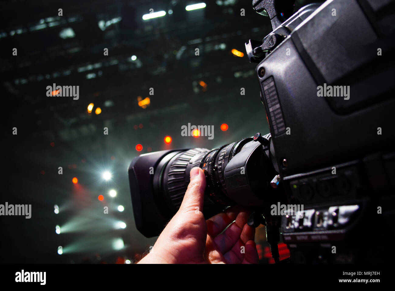 Professional video camera man film concert on stage.Big pro 4k video