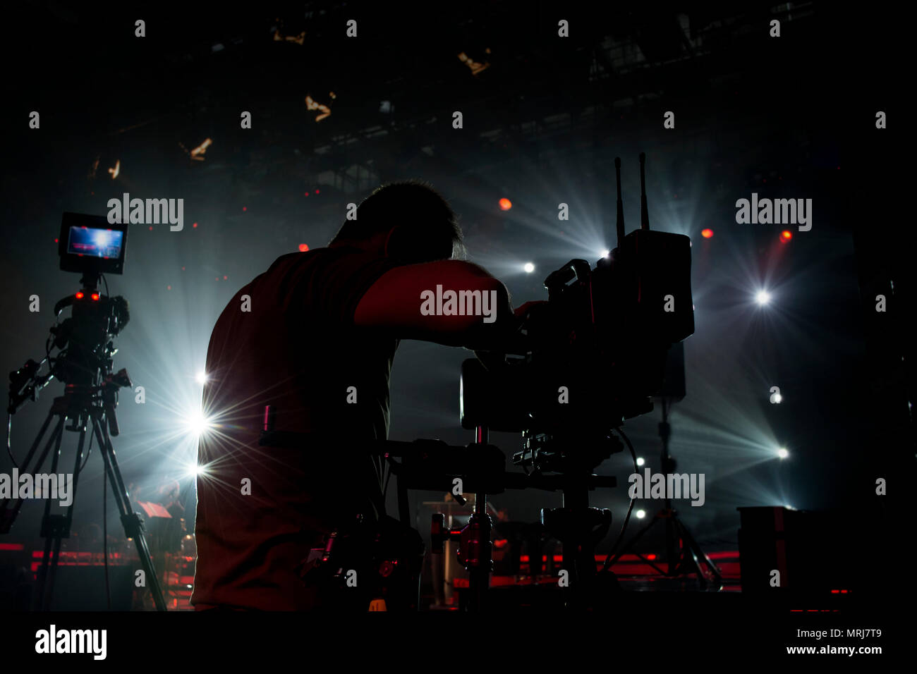 silhouette cameraman in the concert area and steadicam and professional camera Stock Photo