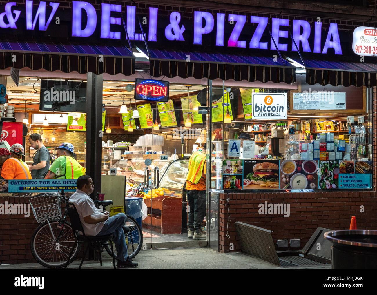 New York, USA. A Bitcoin ATM is advertised in the window of a New York city  deli. Photo by Enrique Shore Stock Photo - Alamy