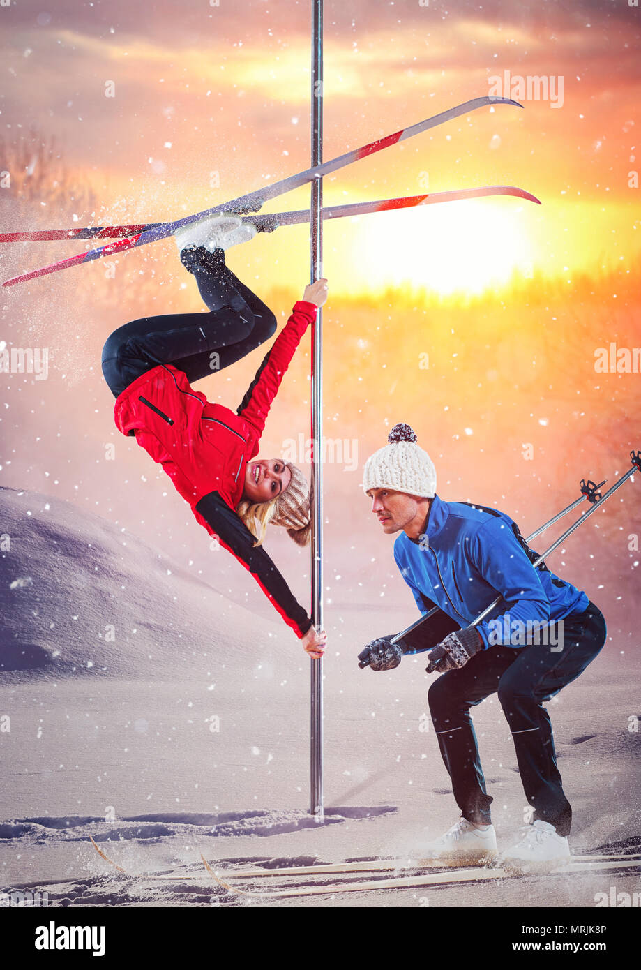 Young couple of pole dancers training at winter outdoors with ski and warm clothing creative concept. Stock Photo