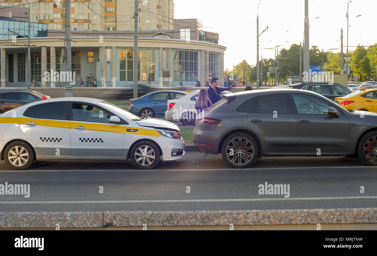Traffic accident involving taxi and car on the road. Stock Photo