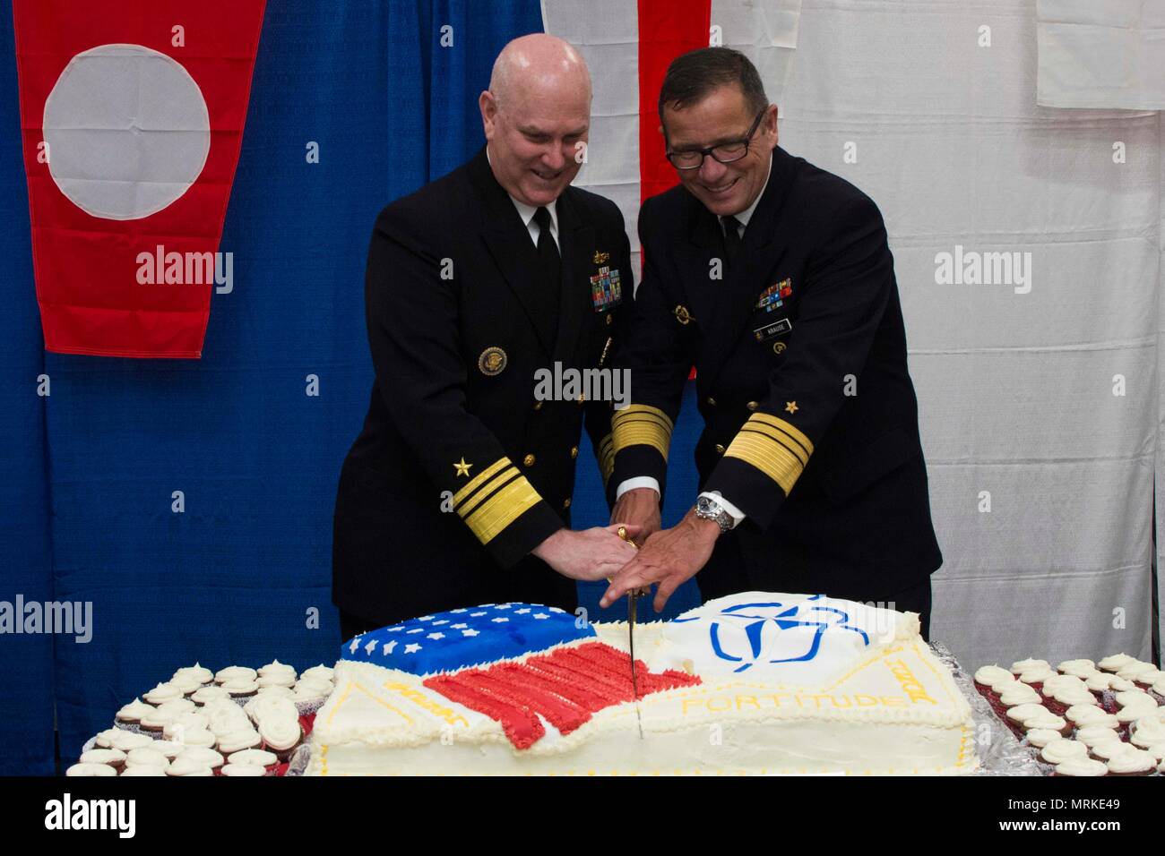 170616-N-GG458-124 KIEL, Germany (June 16, 2017) Vice Adm. Christopher Grady, commander, Naval Striking and Support Forces NATO, left, and German Navy Vice Adm. Andreas Krause, Inspector of the German Navy, cut a cake at a reception aboard the San Antonio-class amphibious transport dock ship USS Arlington (LPD 24) during exercise BALTOPS 2017, June 16. BALTOPS 17 is the premier annual maritime-focused exercise in the Baltic region and one of the largest exercises in Northern Europe. (U.S. Navy photo by Mass Communication Specialist 2nd Class Stevie Tate/Released) Stock Photo