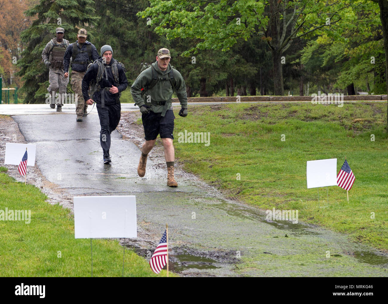 Staff Sgts. Daniel Fox, Andrew Pierce, Thorne Tayamen and Samuel Burke, all assigned to the 66th Security Forces Squadron, participate in a three-mile Air Force Office of Special Investigations Memorial Ruck March at Hanscom Air Force Base, Mass., May 15. The march was held as part of National Police Week, celebrated May 15 through 19, to pay special recognition to SFS and OSI personnel who have lost their lives in the line of duty for the safety and protection of others since 9/11. (U.S. Air Force photo by Jerry Saslav) Stock Photo