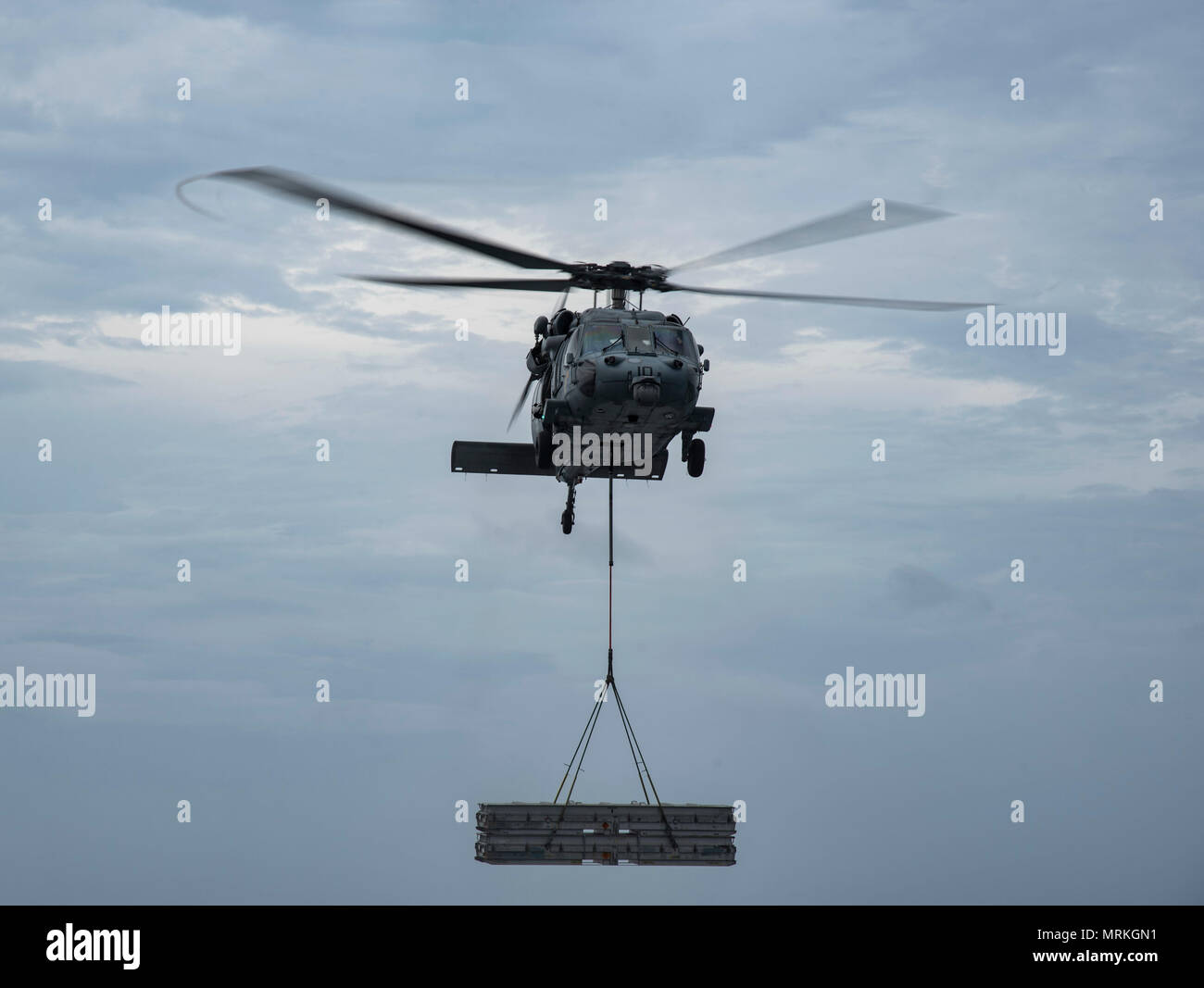 170620-N-QI061-044   ATLANTIC OCEAN (June 20, 2017) An MH-60S Sea Hawk assigned to the Dusty Dogs of Helicopter Sea Combat Squadron (HSC) 7 delivers ammunition crates to the Military Sealift Command dry cargo and ammunition ship USNS Medgar Evers (T-AKE 13) during an ammunition off load with the aircraft carrier USS Dwight D. Eisenhower (CVN 69) (Ike). Ike is underway during the sustainment phase of the Optimized Fleet Response Plan (OFRP). (U.S. Navy photo by Mass Communication Specialist 3rd Class Nathan T. Beard) Stock Photo