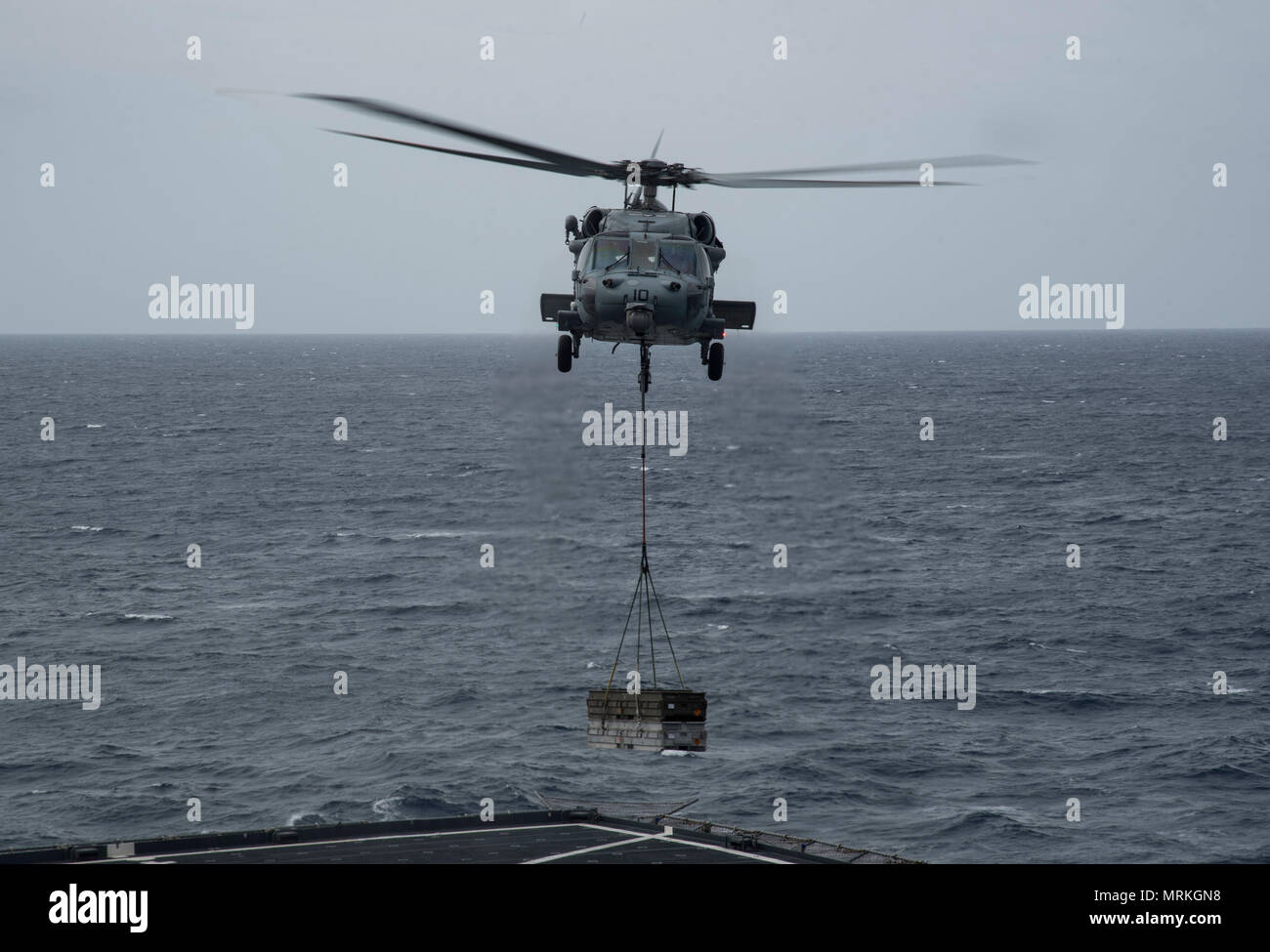 170620-N-QI061-088   ATLANTIC OCEAN (June 20, 2017) MH-60S Sea Hawk assigned to the Dusty Dogs of Helicopter Sea Combat Squadron (HSC) 7 delivers ammunition crates to the Military Sealift Command dry cargo and ammunition ship USNS Medgar Evers (T-AKE 13) during an ammunition off load with the aircraft carrier USS Dwight D. Eisenhower (CVN 69) (Ike). Ike is underway during the sustainment phase of the Optimized Fleet Response Plan (OFRP). (U.S. Navy photo by Mass Communication Specialist 3rd Class Nathan T. Beard) Stock Photo