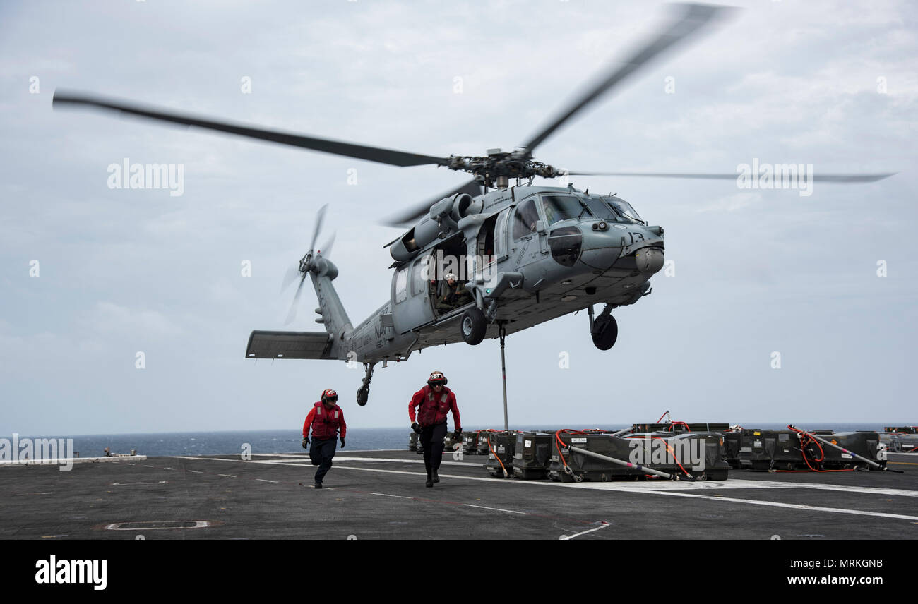 170620-N-QI061-143   ATLANTIC OCEAN (June 20, 2017) An MH-60S Sea Hawk assigned to the Dusty Dogs of Helicopter Sea Combat Squadron (HSC) 7 lifts ammunition crates from the flight deck of the aircraft carrier USS Dwight D. Eisenhower (CVN 69) (Ike) during an ammunition off load with the Military Sealift Command dry cargo and ammunition ship USNS Medgar Evers (T-AKE 13). Ike is underway during the sustainment phase of the Optimized Fleet Response Plan (OFRP). (U.S. Navy photo by Mass Communication Specialist 3rd Class Nathan T. Beard) Stock Photo