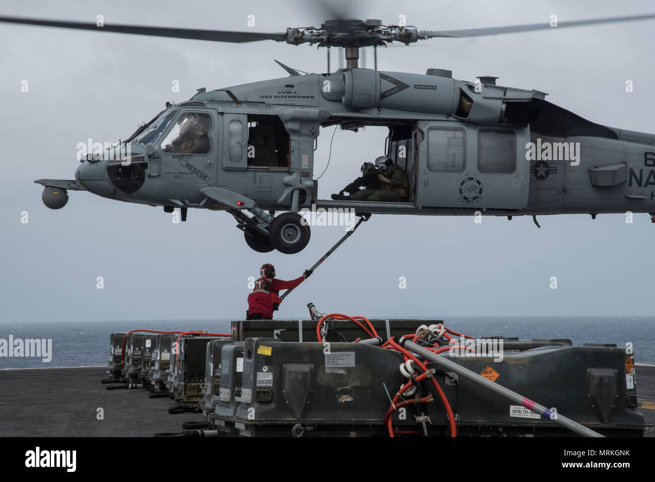 170620-N-QI061-170   ATLANTIC OCEAN (June 20, 2017) Aviation Ordnanceman Airman Trevor Stults, from Portland, Maine, right, and Airman Timothy Cruz, from New York City, connects a 'pogo stick' to an MH-60S Sea Hawk assigned to the Dusty Dogs of Helicopter Sea Combat Squadron (HSC) 7 during a ammunition offload aboard the aircraft carrier USS Dwight D. Eisenhower (CVN 69)(Ike). Ike is underway during the sustainment phase of the Optimized Fleet Response Plan (OFRP). (U.S. Navy photo by Mass Communication Specialist 3rd Class Nathan T. Beard) Stock Photo