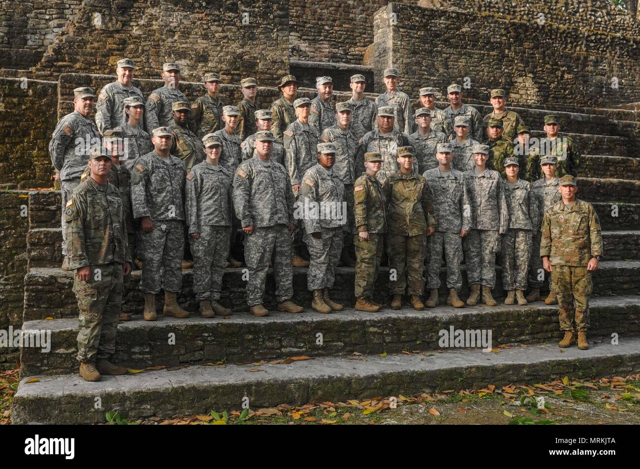 A contingent of medical professionals serving with the Wyoming Army National Guard, Medical Detachment, and three Columbian military doctors pose for a photo on Mayan ruins at the Cahal Pech Archeological Reserve, May 16, 2017. The medical team and other foreign and local medical professionals administered free medical treatment to over 5,300 patients over a 10-day period. (US Army Photo by Sgt. 1st Class Whitney Houston) Stock Photo