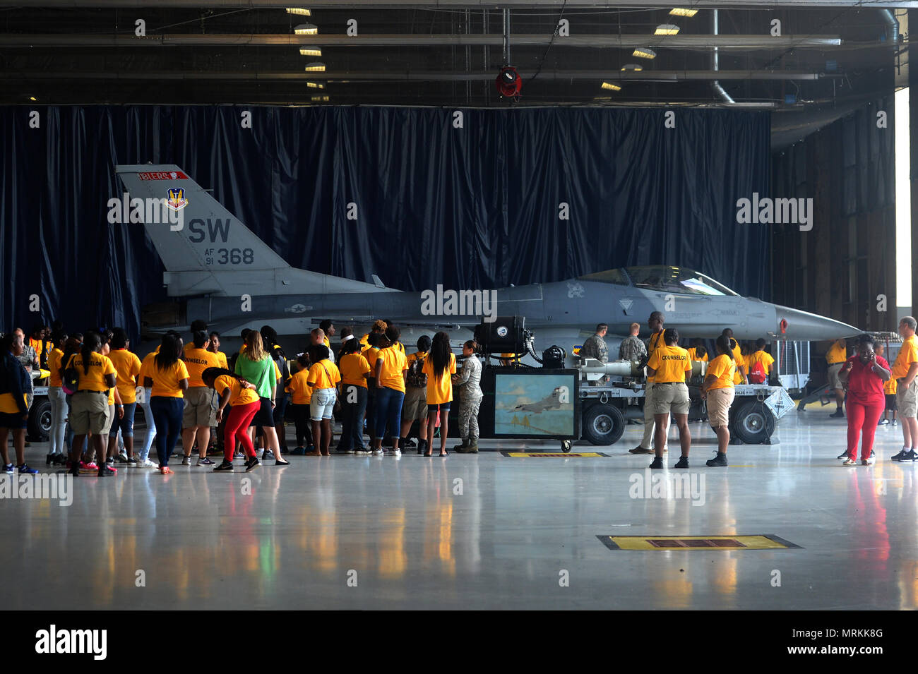 Attendees of the Sumter County Sheriff’s Office’s annual youth conference are briefed about the capabilities of the F-16CM Fighting Falcon at Shaw Air Force Base, S.C., June 16, 2017. During the conference, attendees safely interacted with a M61A1 Vulcan 20 mm rotary cannon, inert bombs and other 20th Fighter Wing weapons and equipment. (U.S. Air Force photo by Airman 1st Class Christopher Maldonado) Stock Photo