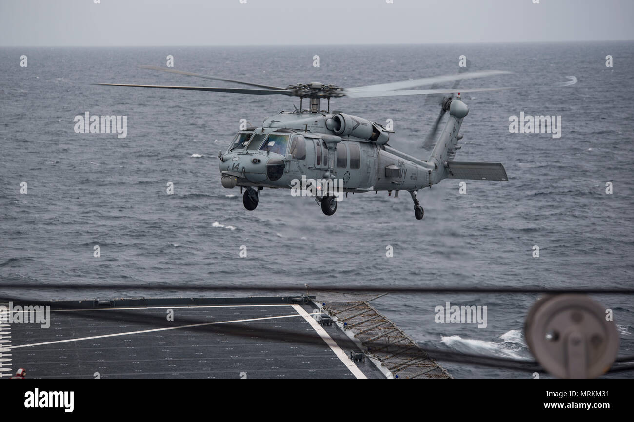 170621-N-QI061-061   ATLANTIC OCEAN (June 21, 2017) An MH-60S Sea Hawk assigned to the Dusty Dogs of Helicopter Sea Combat Squadron (HSC) 7 takes off from the flight deck of the Military Sealift Command dry cargo and ammunition ship USNS Medgar Evers (T-AKE 13) during an ammunition offload with the aircraft carrier USS Dwight D. Eisenhower (CVN 69) (Ike). Ike is underway during the sustainment phase of the Optimized Fleet Response Plan (OFRP). (U.S. Navy photo by Mass Communication Specialist 3rd Class Nathan T. Beard) Stock Photo