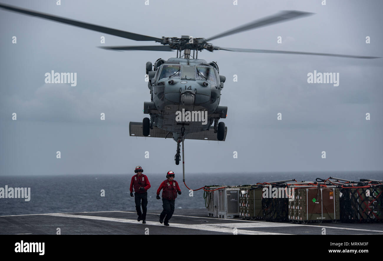 170621-N-QI061-079   ATLANTIC OCEAN (June 21, 2017) An MH-60S Sea Hawk assigned to the Dusty Dogs of Helicopter Sea Combat Squadron (HSC) 7 lifts ammunition crates from the flight deck of the aircraft carrier USS Dwight D. Eisenhower (CVN 69) (Ike) during an ammunition offload with the Military Sealift Command dry cargo and ammunition ship USNS Medgar Evers (T-AKE 13). Ike is underway during the sustainment phase of the Optimized Fleet Response Plan (OFRP). (U.S. Navy photo by Mass Communication Specialist 3rd Class Nathan T. Beard) Stock Photo