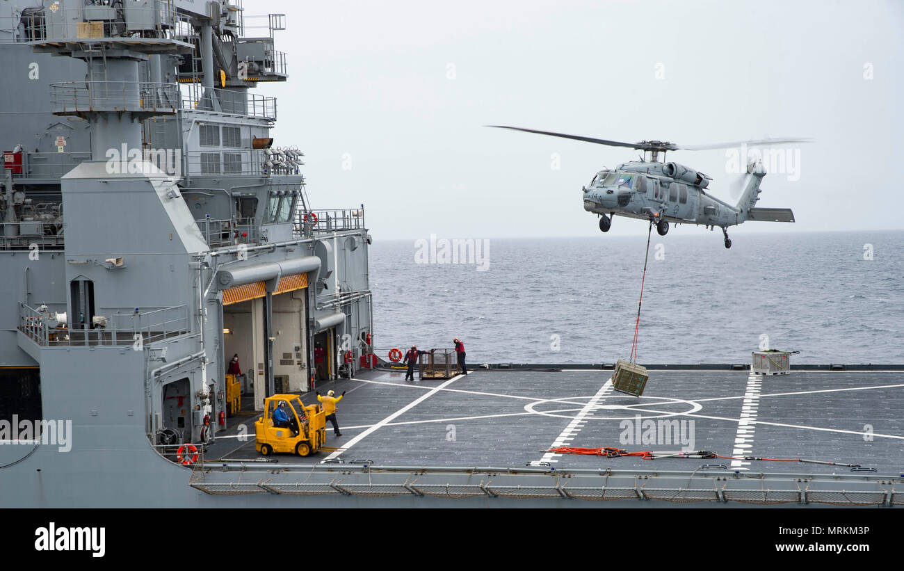 170621-N-QN175-078   ATLANTIC OCEAN (June 21, 2017) An MH-60S Sea Hawk assigned to the Dusty Dogs of Helicopter Sea Combat Squadron (HSC) 7 delivers ammunition crates to the Military Sealift Command dry cargo and ammunition ship USNS Medgar Evans (T-AKE 13) from the aircraft carrier USS Dwight D. Eisenhower (CVN 69)(Ike). Ike is underway during the sustainment phase of the Optimized Fleet Response Plan (OFRP). (U.S. Navy photo by Mass Communication Specialist 3rd Class Dartez C. Williams) Stock Photo