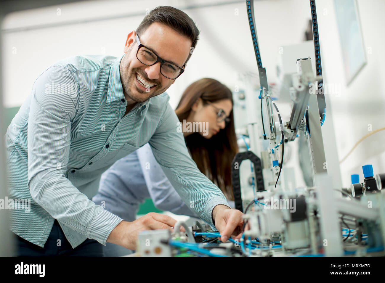 Young couple of students working at robotics lab Stock Photo