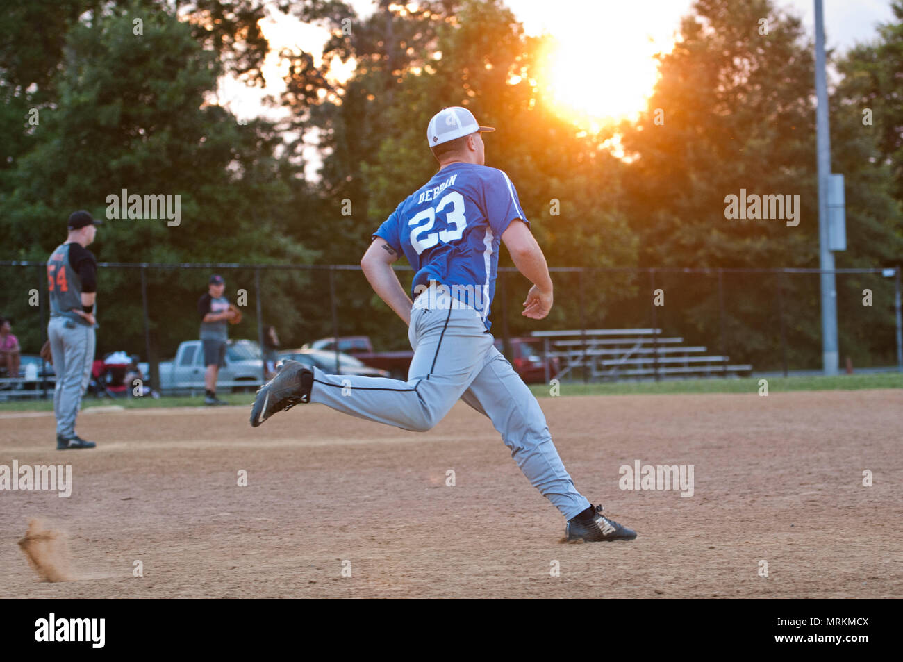 22nd Intelligence Squadron infielder rounds the bases during an Intramural Softball game against the 94th Intelligence Squadron, June 21, 2017 at Fort George G. Meade. 22nd IS won by a score of 10-0. (U.S. Air Force photo/Tech. Sgt. Mark Thompson) Stock Photo