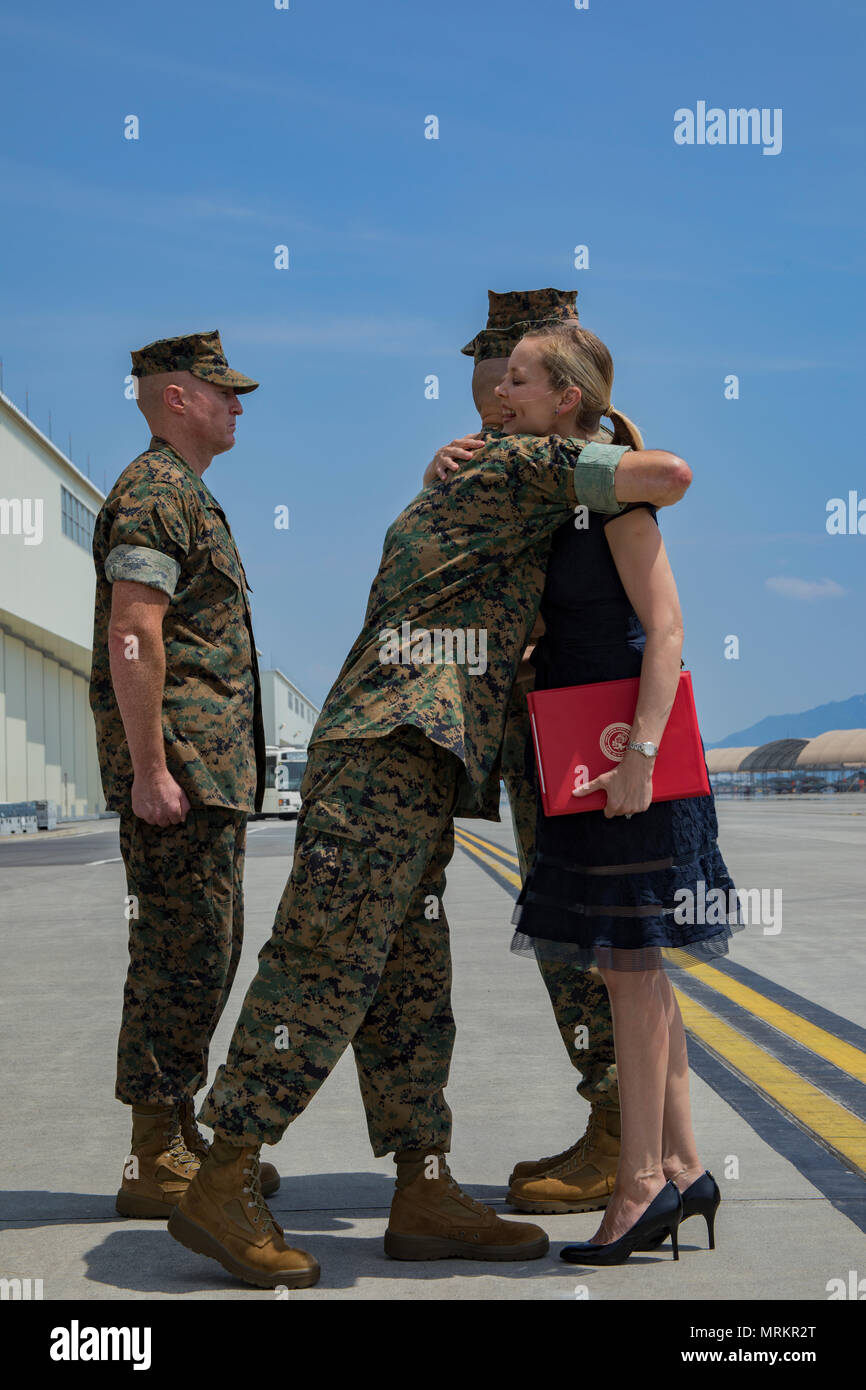 U.S. Marine Corps Maj. Gen. Russell A. Sanborn, left, the commanding general of 1st Marine Aircraft Wing, III Marine Expeditionary Force, hugs Mrs. Kimberly Shipley, right, wife of former Marine Aircraft Group (MAG) 12 commanding officer, after an award presentation, during a change of command ceremony at Marine Corps Air Station Iwakuni, Japan, June 23, 2017. After two years of dedicated service to MAG-12, U.S. Marine Corps Col. Daniel Shipley was relieved of his duties to continue on and serve in Washington D.C. at Headquarters Marine Corps with Programs and Resources. (U.S. Marine Corps pho Stock Photo