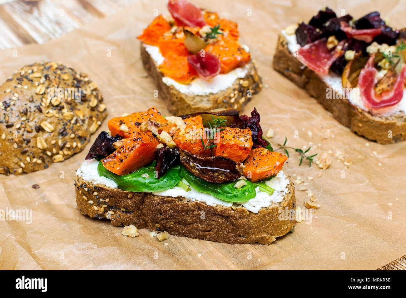 Bruschetta with pumpkin, prosciutto, cream cheese and onion Stock Photo