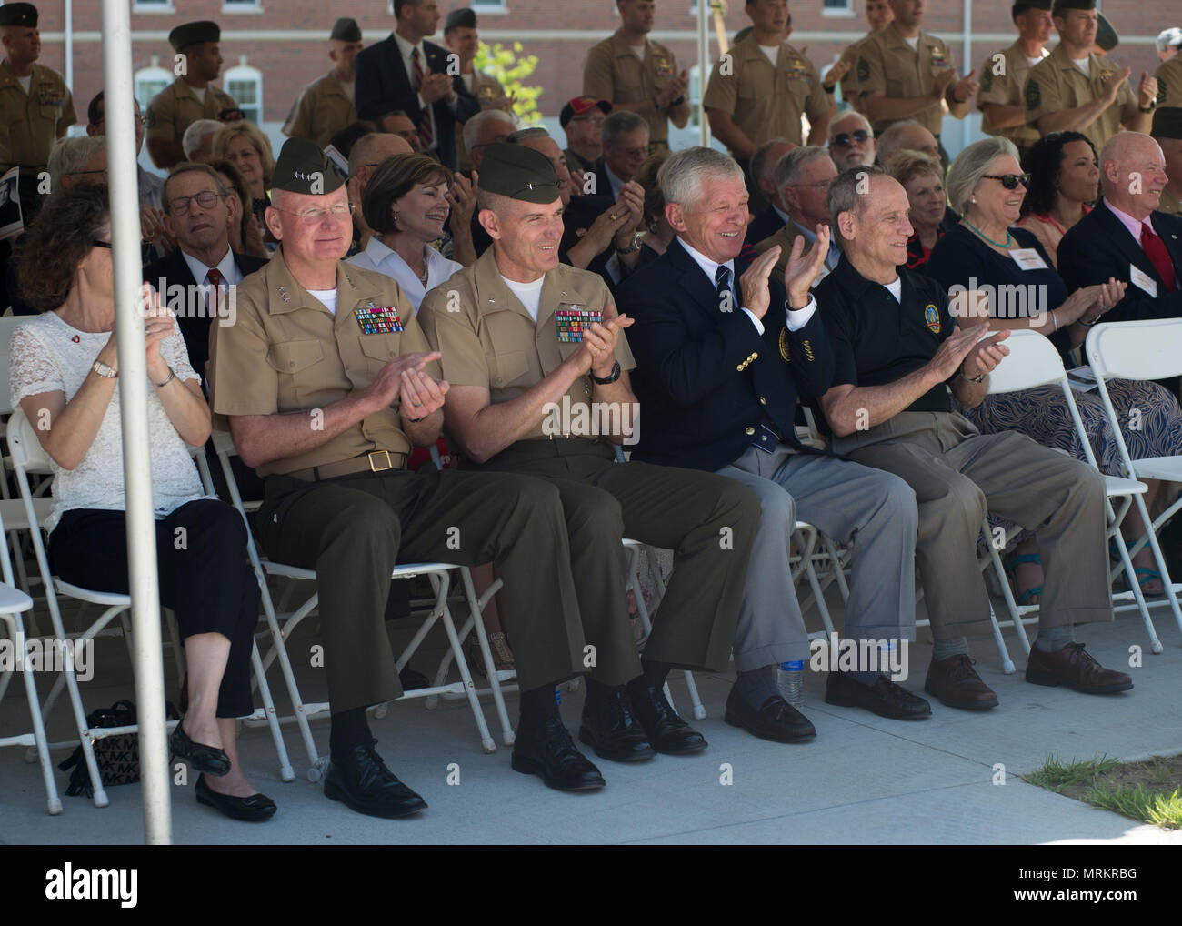U.S. Marines and attendees clap during the Graves Hall dedication
