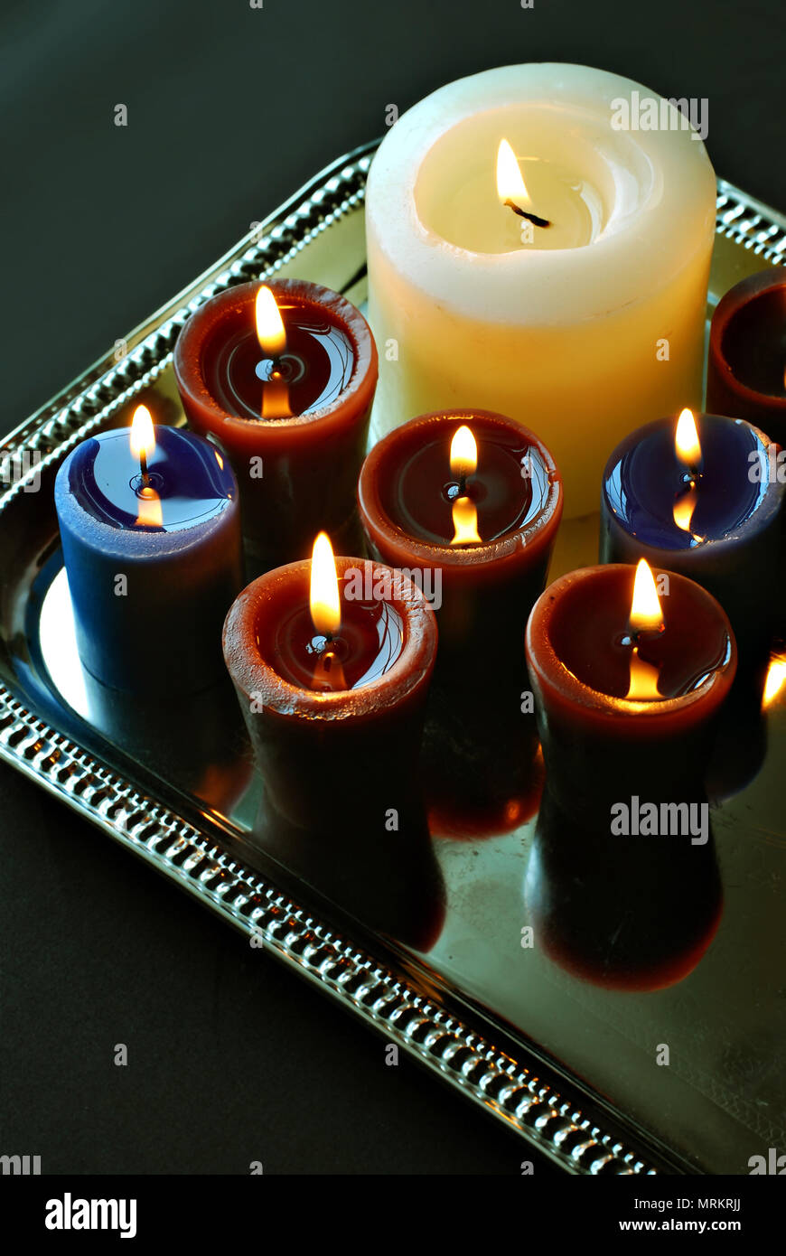 Multiple lit wax candles hi-res stock photography and images - Alamy