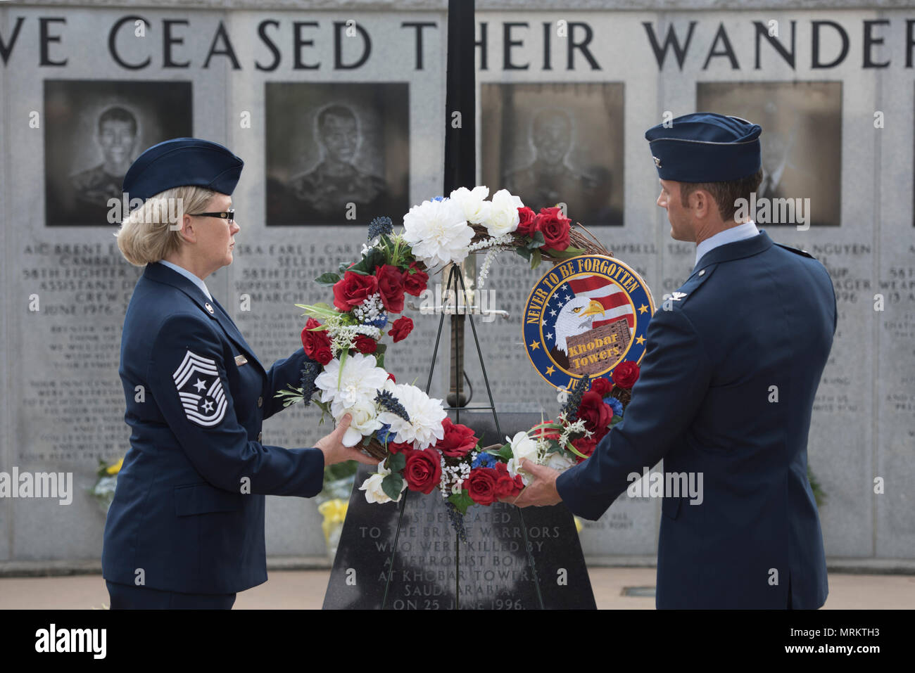 U.S. Air Force Col. Paul Moga, 33rd Fighter Wing commander, right, and Chief Master Sgt. Shelley Cohen, 307th Bomb Wing command chief, place a wreath in front of the burning sword during the Khobar Towers 21st Anniversary Wreath Laying Ceremony June 23, 2017, at Eglin Air Force Base, Florida. On June 25, 1996, a bomb was detonated near the Khobar Towers housing complex in Dhahran, Saudi Arabia. Nineteen Airmen were killed and more than 400 U.S. and international military and civilians were injured in the blast.  Of the 19 killed, 12 were Nomads. Each year the 33 FW holds a ceremony in remembra Stock Photo