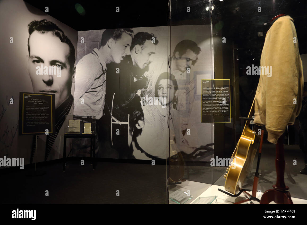 Elvis Presley's stage costume and guitar display in front of Million Dollar Quartet photo in Elvis,Entertainer Career Museum in Graceland.Memphis .USA Stock Photo