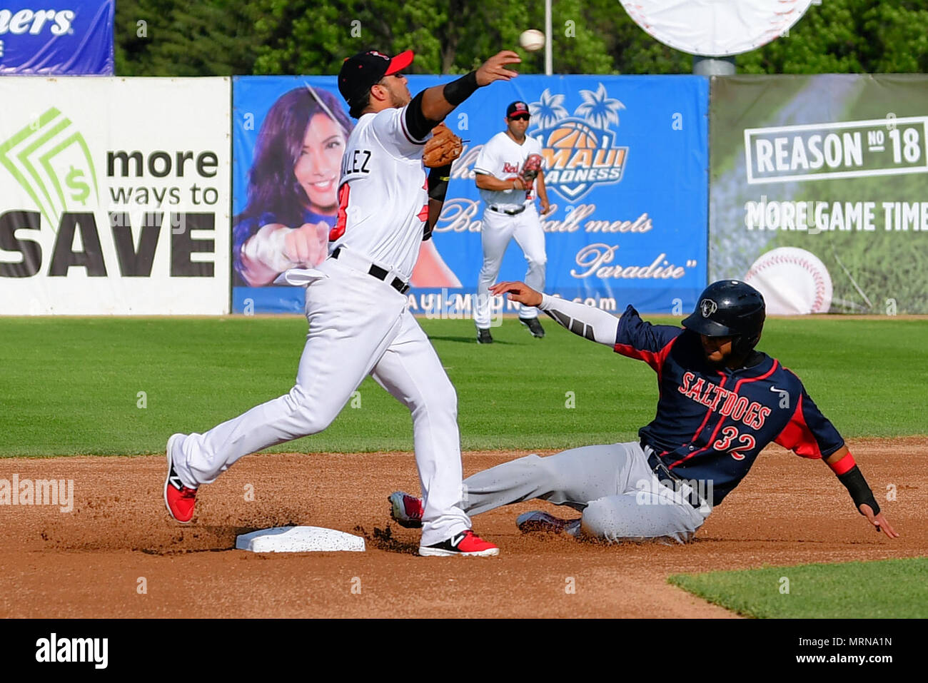 Fargo, ND, USA. 26th May, 2018. Lincoln Saltdogs outfielder Angel Reyes  (32) slides into second base as FM RedHawk Maikol Gonzalez (3)attempts to  turn the double play in American Association professional baseball