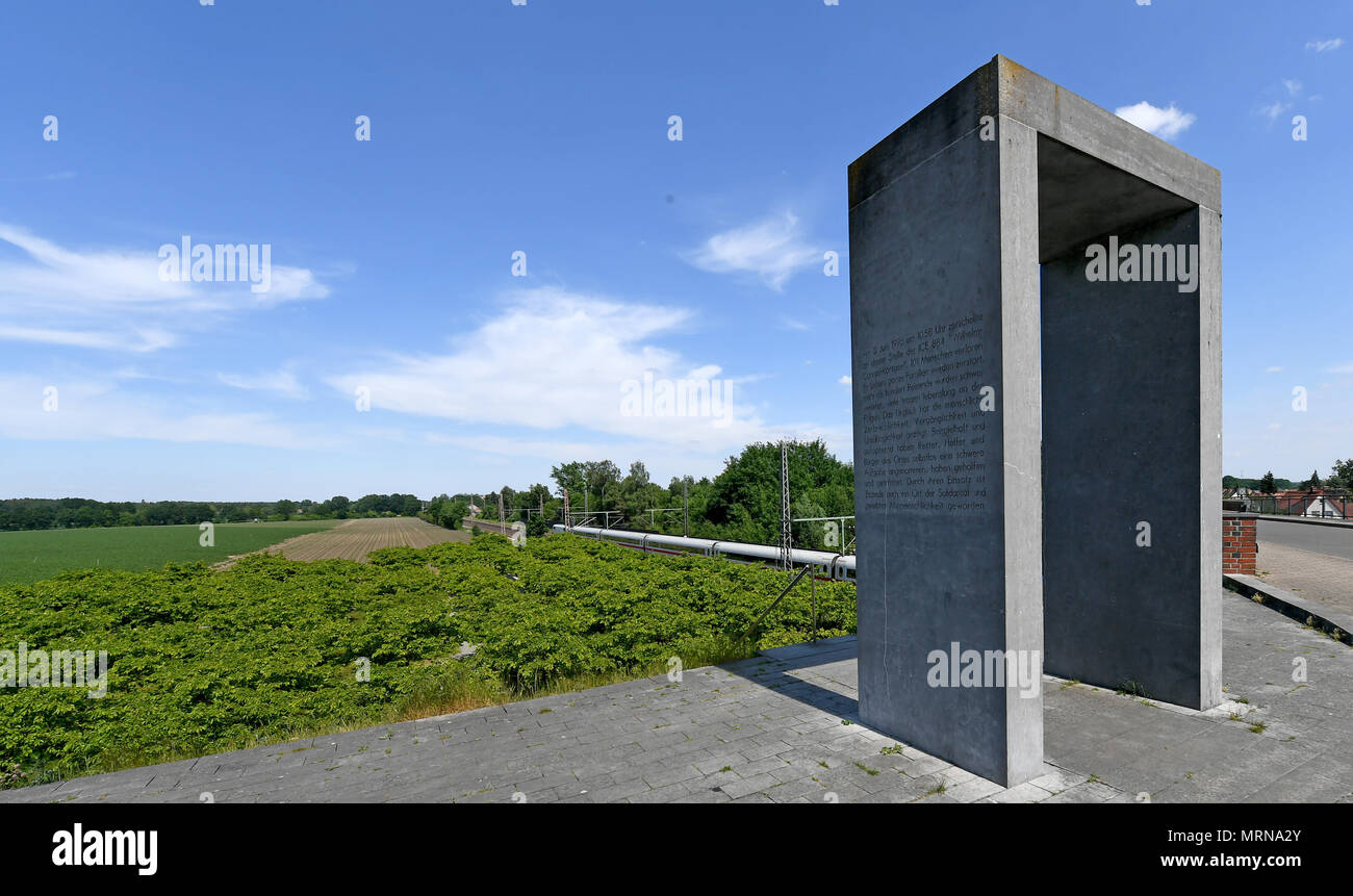 24 May 2018, Germany, Eschede: An Inter City Express (ICE) train passes the memorial for the 1998 Eschede ICE derailment. On 3 June 1998, the ICE 884 'Wilhelm Conrad Roentgen' derailed on the Hannover-Hamburg route near the village of Eschede. 101 people died. Photo: Holger Hollemann/dpa Stock Photo