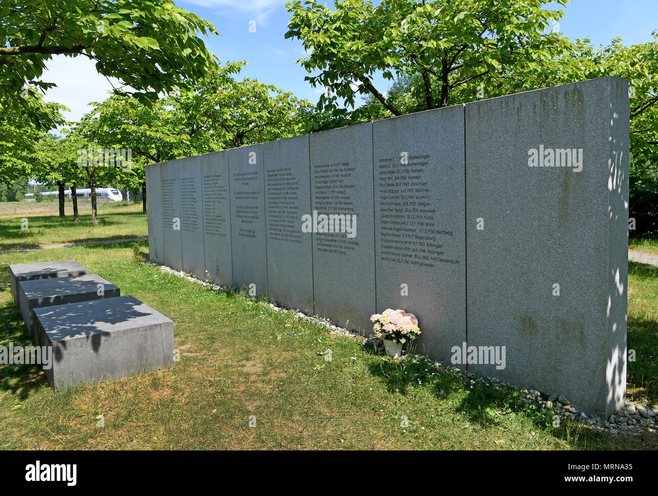 24 May 2018, Germany, Eschede: An Inter City Express (ICE) train passes the memorial site for the 1998 Eschede ICE derailment, where 101 cherry trees have been planted. On 3 June 1998, the ICE 884 'Wilhelm Conrad Roentgen' derailed on the Hannover-Hamburg route near the village of Eschede. 101 people died. Photo: Holger Hollemann/dpa Stock Photo