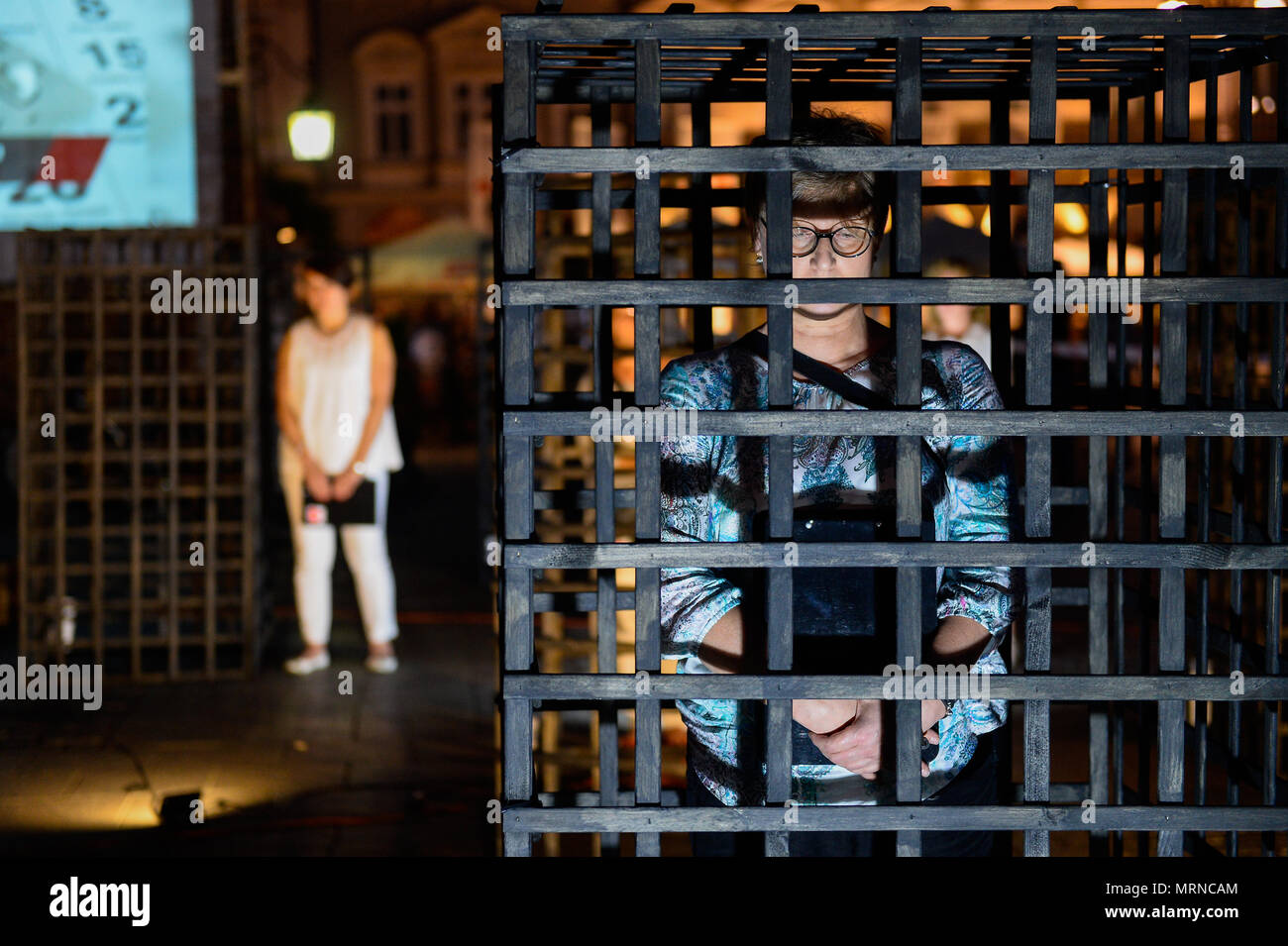 Krakow, Poland. 26 May 2018. A woman seen inside a cage during a demonstration. Women take part in a ‘performance’ protest inside several cages in the Main Square to express their solidarity for the Women right during Mother Day in Krakow. Credit: SOPA Images Limited/Alamy Live News Stock Photo