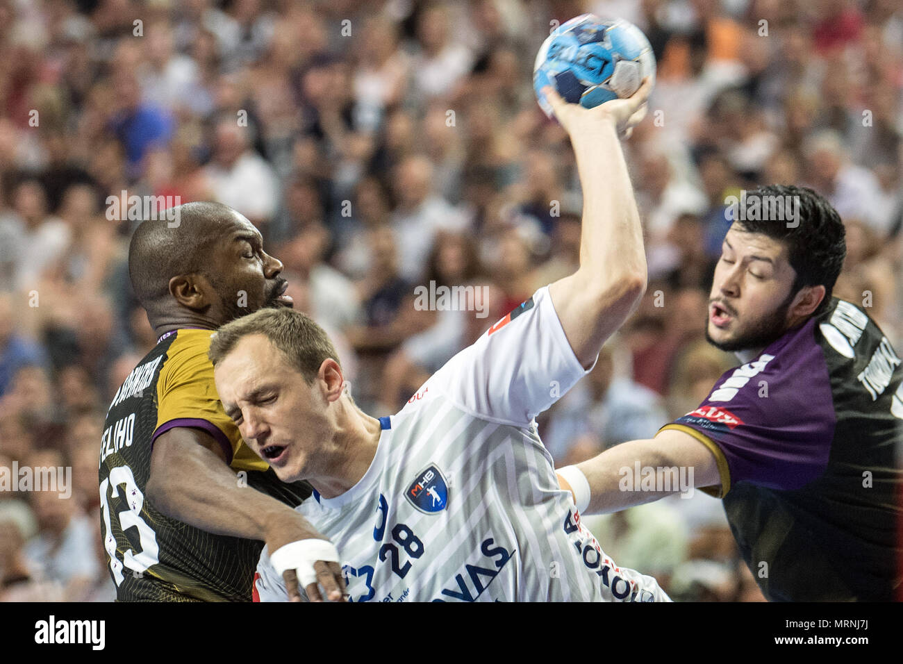 27 May 2018, Germany, Cologne: Handball Champions League final, HBC Nantes vs Montpellier HB at the Lanxess Arena: Rock Feliho (l) of Nantes and Valentin Porte of Montpellier vie for the ball. Photo: Federico Gambarini/dpa Stock Photo