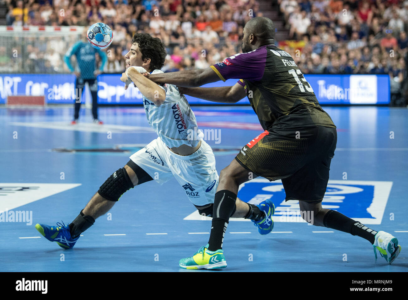27 May 2018, Germany, Cologne: Handball Champions League final, HBC Nantes vs Montpellier HB at the Lanxess Arena: Rock Feliho (r) of Nantes and Diego Simonet of Montpellier vie for the ball. Photo: Federico Gambarini/dpa Stock Photo