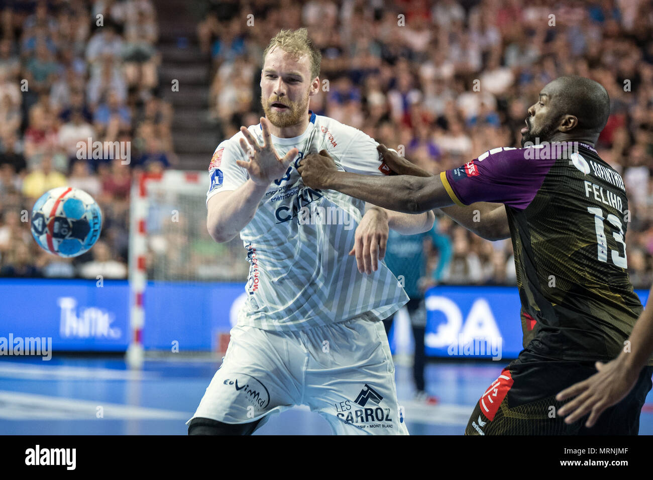 27 May 2018, Germany, Cologne: Handball Champions League final, HBC Nantes vs Montpellier HB at the Lanxess Arena: Rock Feliho (r) of Nantes and Jonas Truchanovicius of Montpellier vie for the ball. Photo: Federico Gambarini/dpa Stock Photo