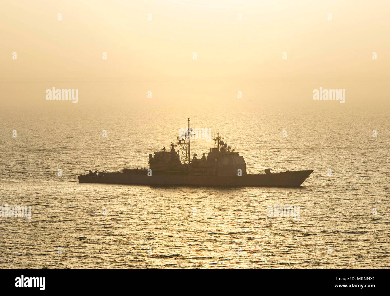 ARABIAN GULF (June 18, 2017) The guided-missile cruiser USS Vella Gulf (CG 72) steams through the Arabian Gulf during Exercise Spartan Kopis 17, June 18.  Exercise Spartan Kopis is a Task Force (TF) 55-led exercise between the U.S. Navy and U.S. Coast Guard in order to increase tactical proficiency, broaden levels of cooperation, enhance mutual capability and support long-term security and stability in the region. Vella Gulf is deployed to the U.S. 5th Fleet area of operations to reassure allies and partners, and preserve the freedom of navigation and the free flow of commerce in the region.   Stock Photo