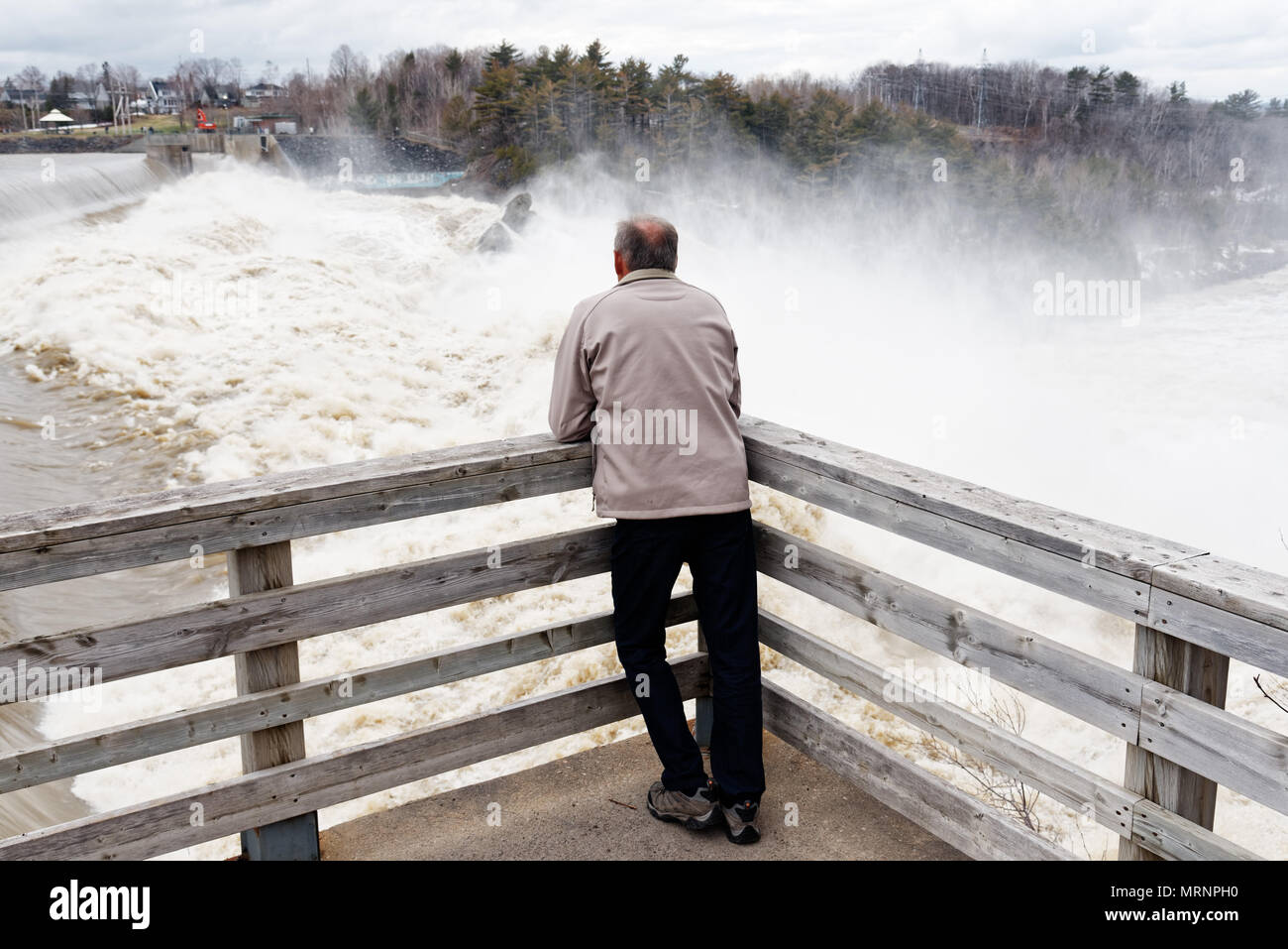 People watching the Chutes de la Chaudiere at Charny near Quebec City in full spring flood Stock Photo