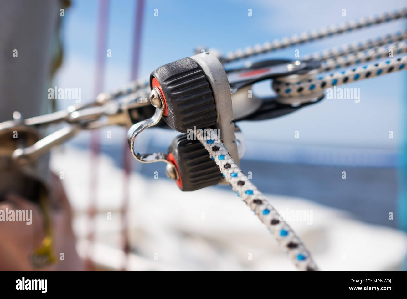 close up on winch and rope of yacht over blue sea Stock Photo