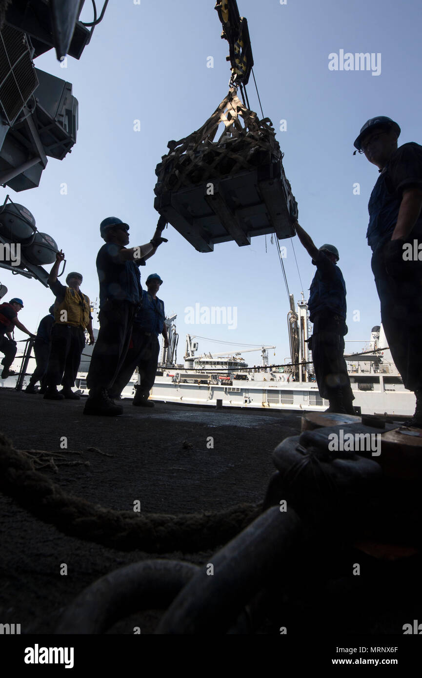 ARABIAN GULF (June 19, 2017) Sailors assigned to the  guided-missile cruiser USS Vella Gulf (CG 72) receive supplies while conducting a replenishment-at-sea with the French navy Durance-class replenishment tanker FS Var (A608), supporting Task Force (TF) 53, during Exercise Spartan Kopis 17, June 19.  Exercise Spartan Kopis is a Task Force (TF) 55led exercise between the U.S. Navy and U.S. Coast Guard in order to increase tactical proficiency, broaden levels of cooperation, enhance mutual capability and support long-term security and stability in the region. Vella Gulf is deployed to the U.S.  Stock Photo