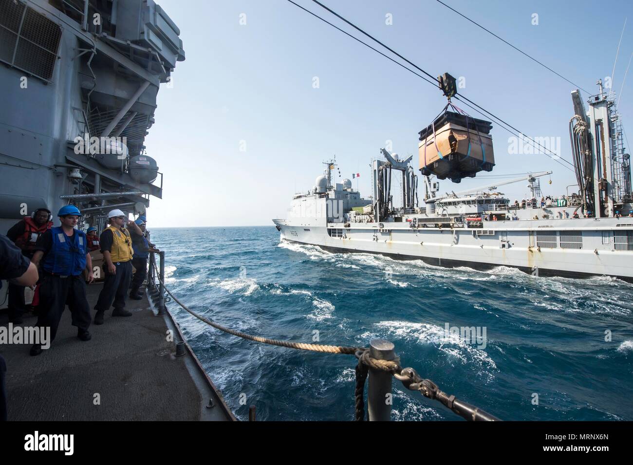 ARABIAN GULF (June 19, 2017) Sailors assigned to the guided-missile cruiser USS Vella Gulf (CG 72) receive supplies while conducting a replenishment-at-sea with the French navy Durance-class replenishment tanker FS Var (A608), supporting Task Force 53,  during Exercise Spartan Kopis 17, June 19.  Exercise Spartan Kopis is a Task Force (TF) 55-led exercise between the U.S. Navy and U.S. Coast Guard in order to increase tactical proficiency, broaden levels of cooperation, enhance mutual capability and support long-term security and stability in the region. Vella Gulf is deployed to the U.S. 5th  Stock Photo