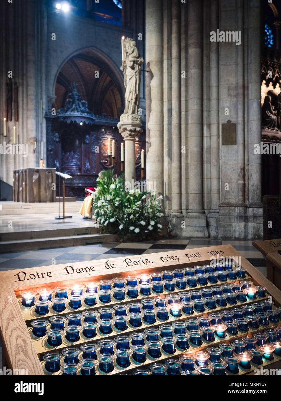 Votive candles inside the Notre Dame cathedral in Paris, France Stock