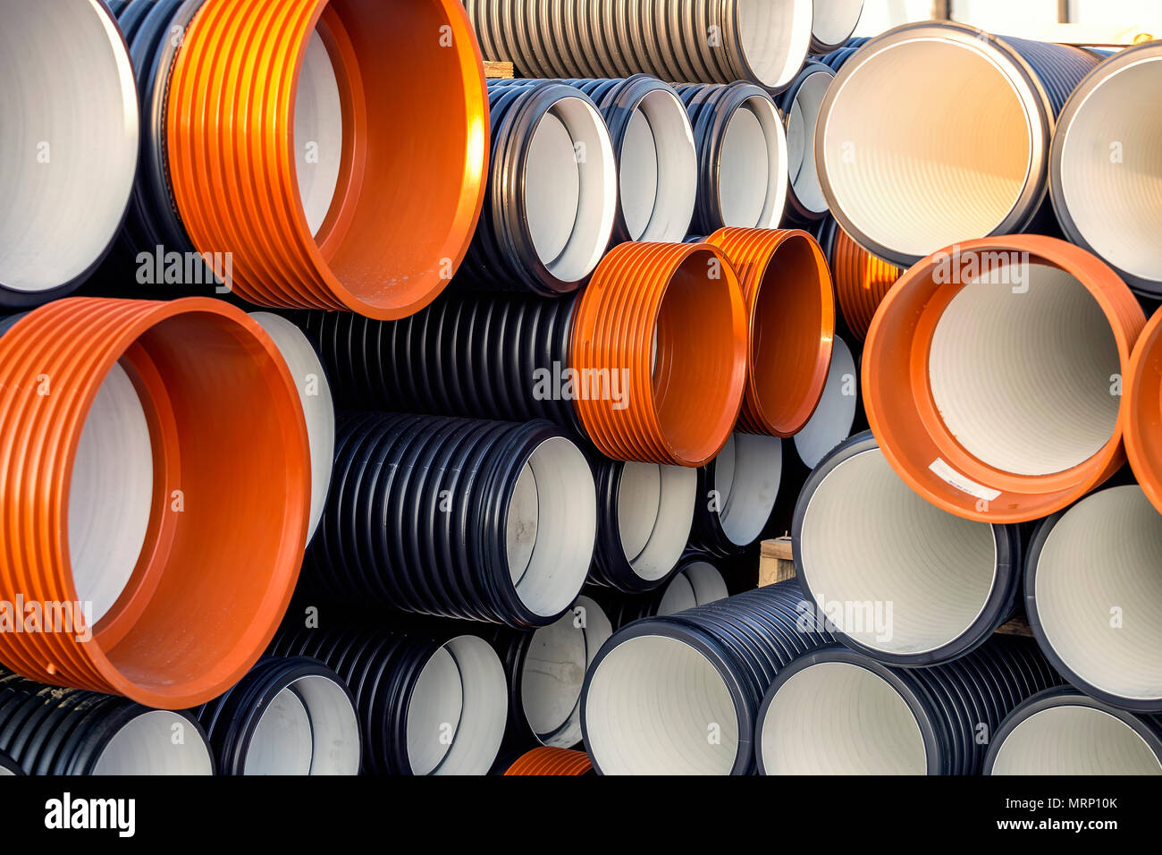 Stack of corrugated PVC sewer or drain pipes of large diameter with