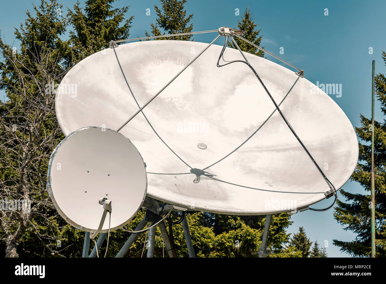 Two big satellite dish outdoor, parabolic antenna. Satellite communication disks. Color effect. Stock Photo