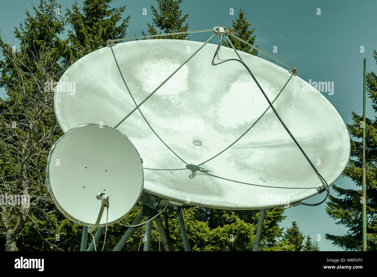Two big satellite dish outdoor, parabolic antenna. Satellite communication disks. Color effect. Stock Photo